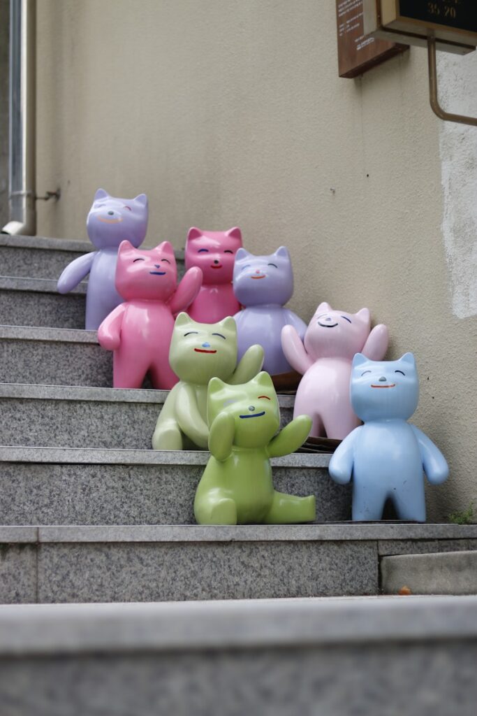 A group of small teddy bears sitting on top of a set of stairs